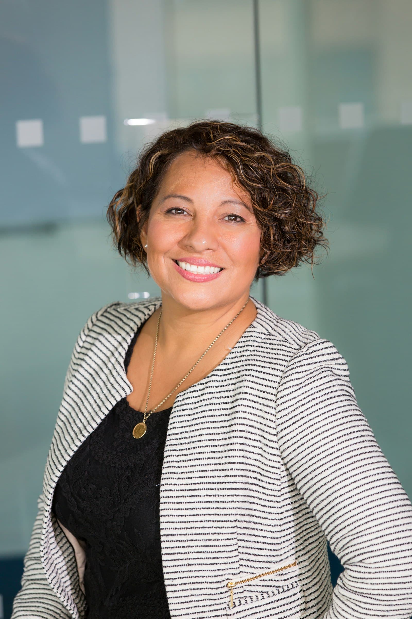 Personal branding portrait of a smiling woman in an office