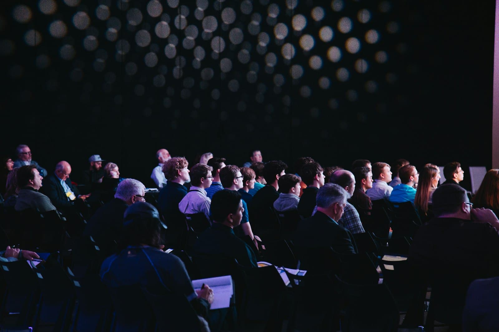 Audience at a conference in low light
